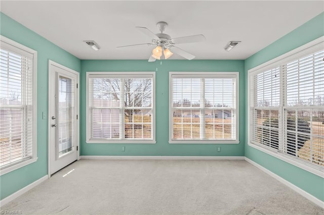 unfurnished sunroom with visible vents and ceiling fan