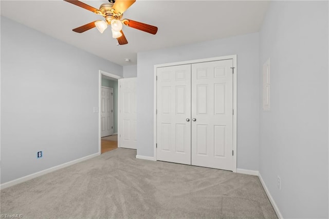 unfurnished bedroom with a closet, ceiling fan, baseboards, and carpet