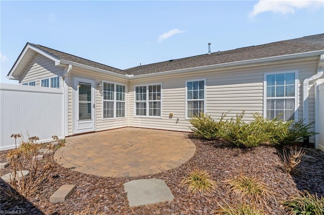 back of property with a patio and fence