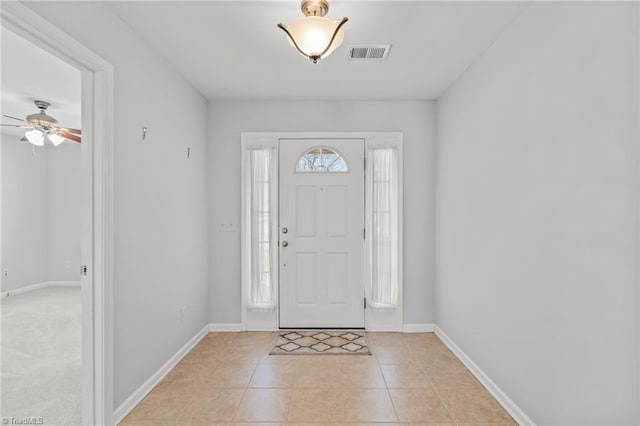 foyer featuring light tile patterned floors, visible vents, and baseboards