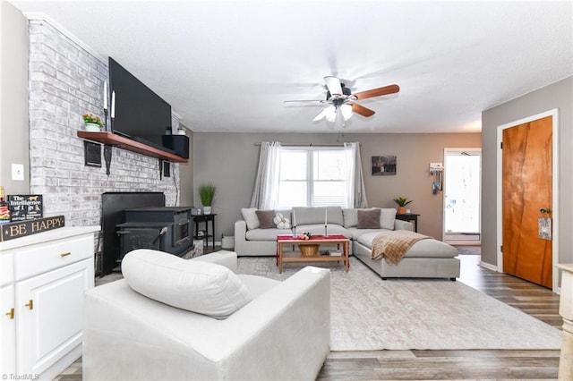 living room with ceiling fan and light hardwood / wood-style flooring