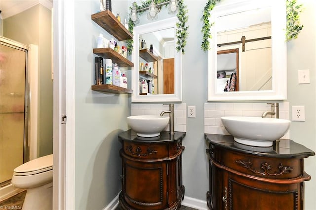 bathroom with a shower with shower door, backsplash, toilet, and vanity