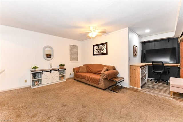 living room featuring crown molding, carpet flooring, and ceiling fan