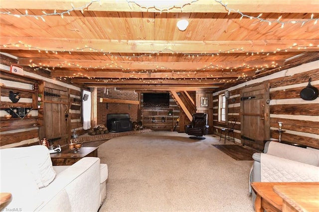 basement featuring wood walls, wooden ceiling, carpet flooring, and a wood stove