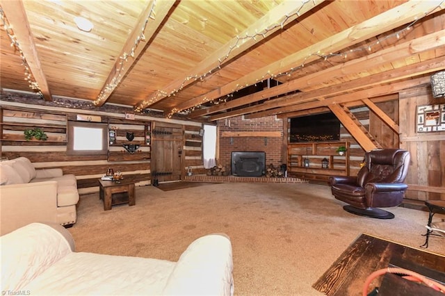 carpeted living room with beam ceiling, a wood stove, and wood walls