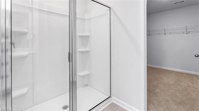 bathroom with a shower with shower door