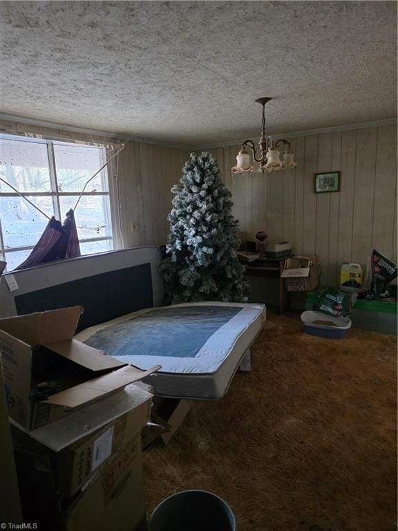 playroom featuring a textured ceiling, carpet flooring, and a notable chandelier