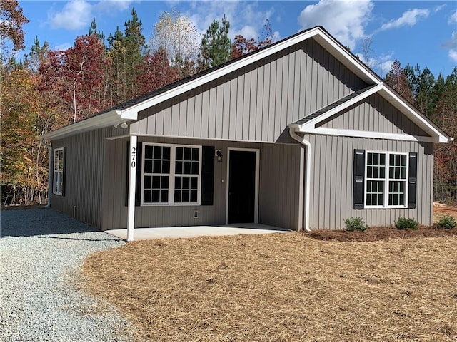 view of front of home featuring board and batten siding and a patio area