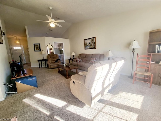 living room with ceiling fan, carpet floors, and lofted ceiling