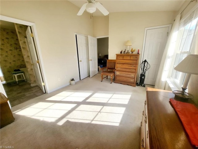 carpeted bedroom with ceiling fan and vaulted ceiling