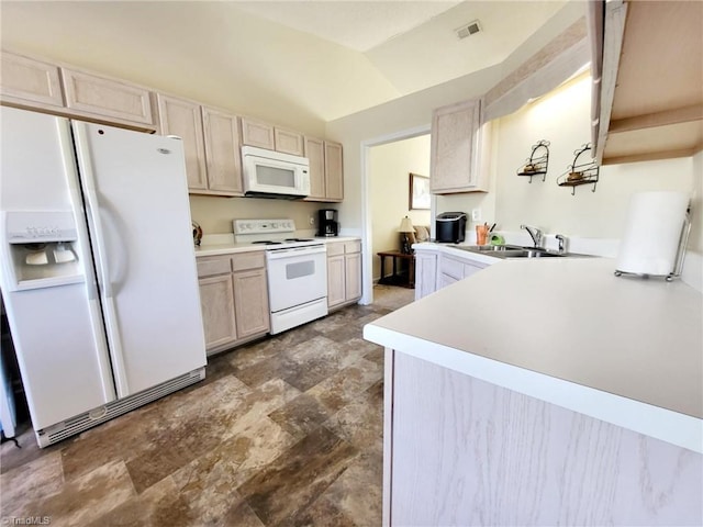 kitchen with white appliances, kitchen peninsula, light brown cabinetry, lofted ceiling, and sink