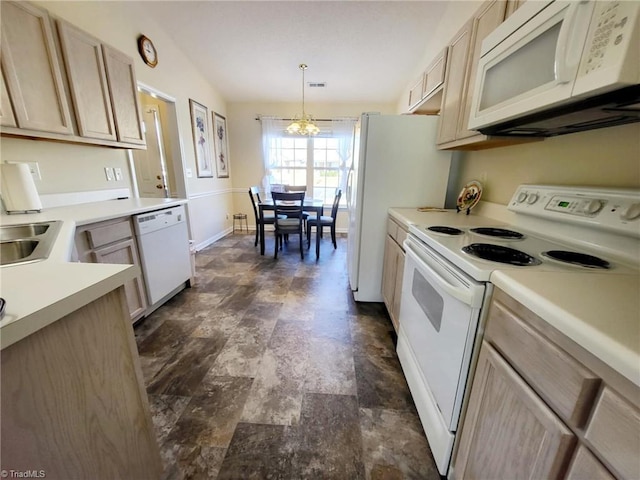 kitchen with white appliances, hanging light fixtures, an inviting chandelier, and light brown cabinetry