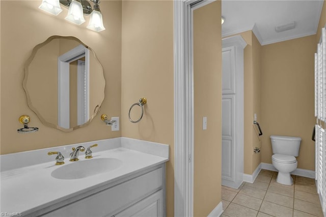 bathroom with ornamental molding, vanity, toilet, and tile patterned floors