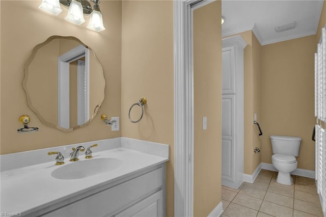 bathroom with tile patterned floors, toilet, baseboards, crown molding, and vanity