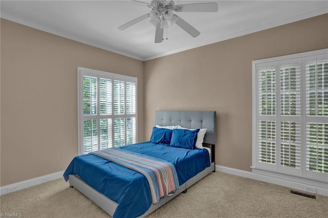 bedroom featuring crown molding, ceiling fan, and light colored carpet