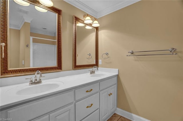 bathroom with crown molding, tile patterned flooring, and vanity