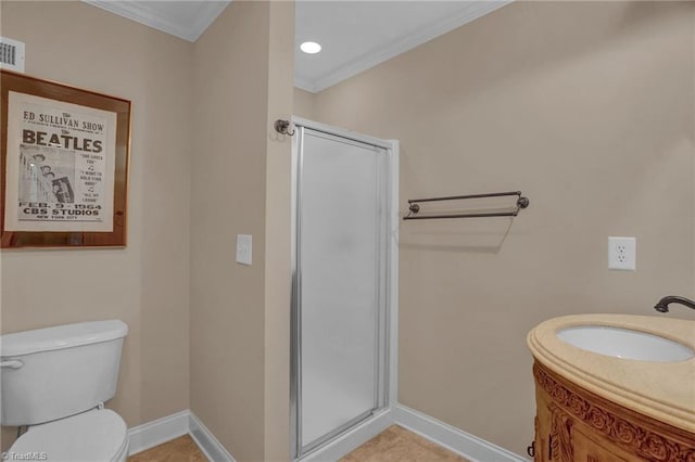 bathroom featuring a shower stall, toilet, a sink, crown molding, and baseboards