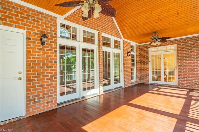 unfurnished sunroom featuring ceiling fan, vaulted ceiling, and wooden ceiling