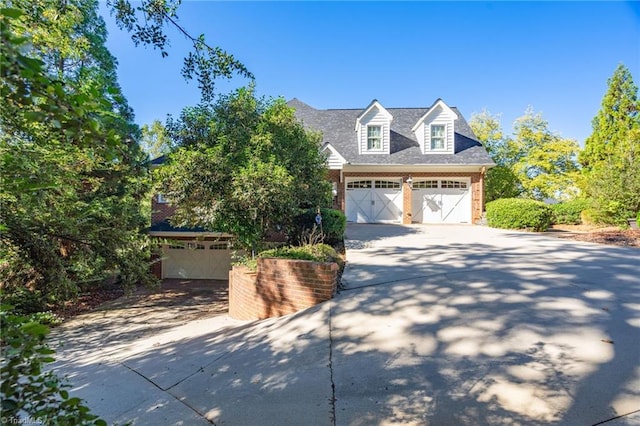 view of front of property featuring a garage, brick siding, and concrete driveway