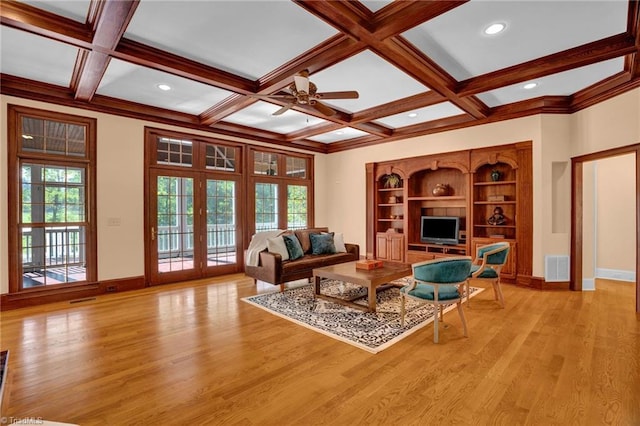 living room with visible vents, beamed ceiling, light wood-style floors, baseboards, and ceiling fan