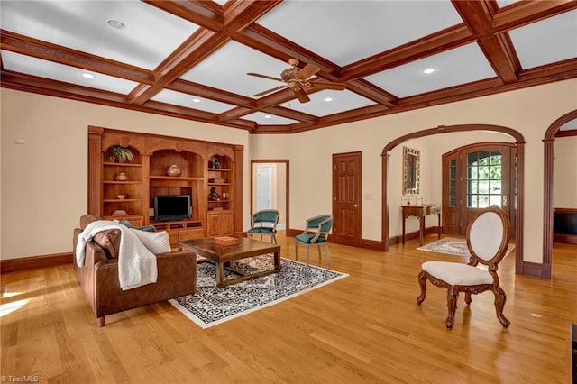 living room with ceiling fan, light wood-type flooring, coffered ceiling, and beam ceiling