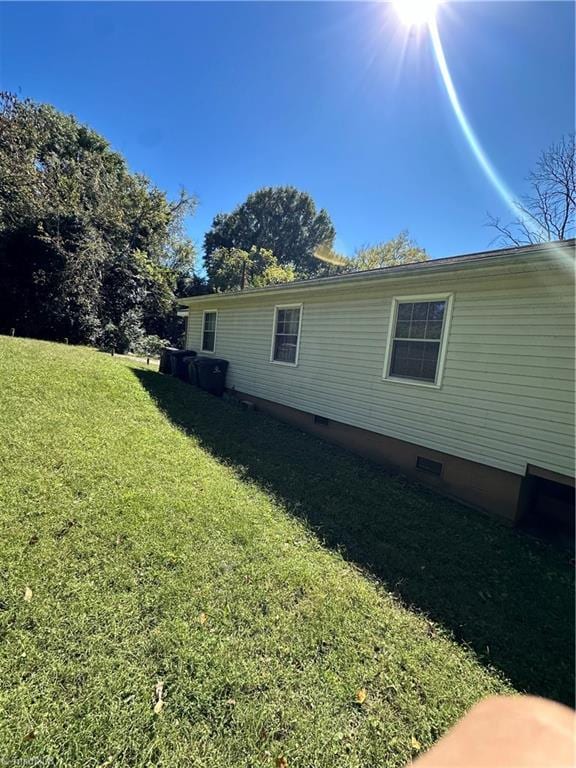 view of property exterior with a lawn