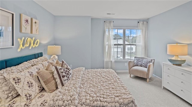 bedroom featuring light colored carpet