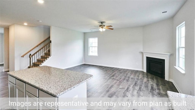 living room featuring hardwood / wood-style floors and ceiling fan