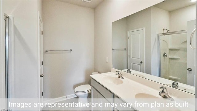 bathroom featuring toilet, a shower with shower door, and vanity