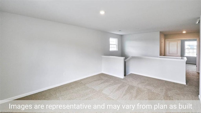 unfurnished room featuring carpet floors and a wealth of natural light