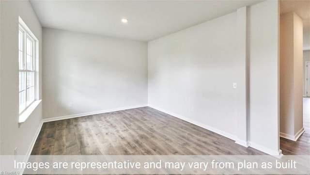 spare room featuring wood-type flooring