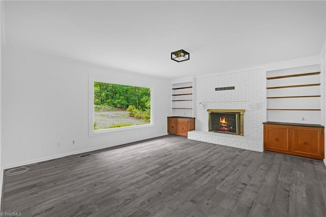 2104 Laura Ln, High Point, NC 27262 - unfurnished living room with a brick fireplace, dark wood-style flooring, and baseboards