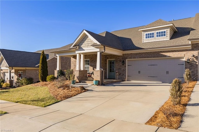 craftsman inspired home featuring a garage and covered porch