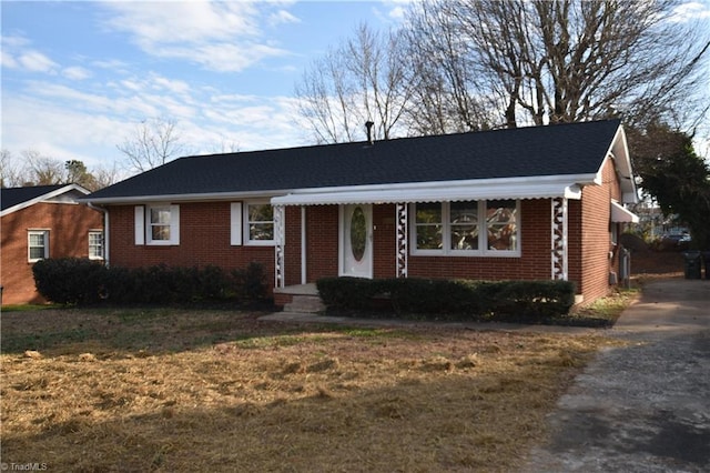 ranch-style home with a front lawn