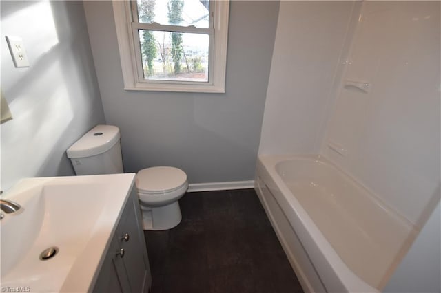 bathroom featuring vanity, a bath, and toilet