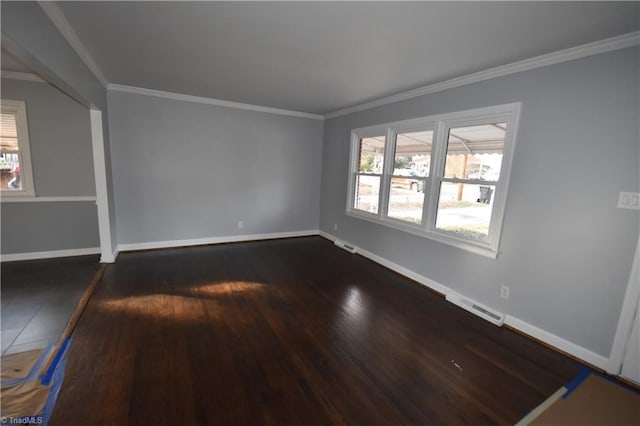 empty room featuring crown molding and dark hardwood / wood-style flooring