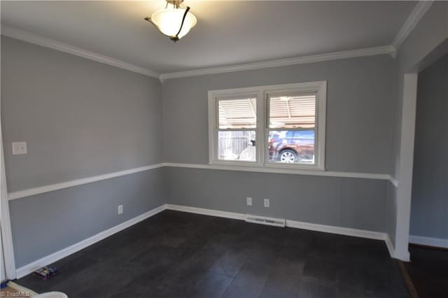 spare room featuring dark wood-type flooring and ornamental molding