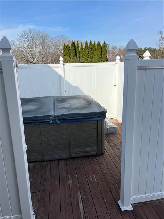 wooden terrace featuring a hot tub