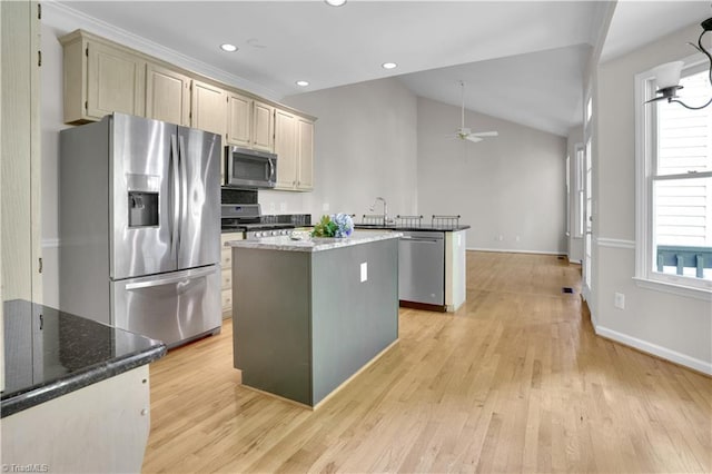 4507 Brandt Ridge Dr, Greensboro, NC 27455 - kitchen with light wood-style flooring, stainless steel appliances, a ceiling fan, lofted ceiling, and a kitchen island
