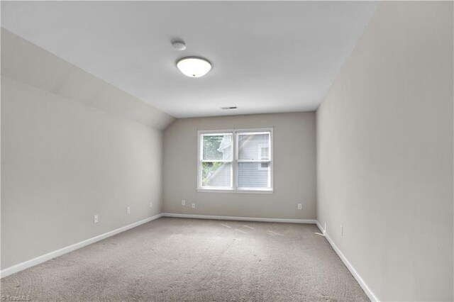 4507 Brandt Ridge Dr, Greensboro, NC 27455 - carpeted spare room featuring baseboards, vaulted ceiling, and visible vents