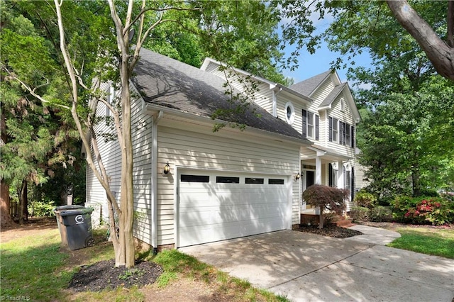 4507 Brandt Ridge Dr, Greensboro, NC 27455 - view of home's exterior featuring roof with shingles, an attached garage, and concrete driveway