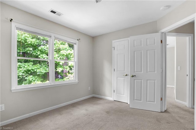 4507 Brandt Ridge Dr, Greensboro, NC 27455 - unfurnished bedroom with baseboards, light carpet, and visible vents