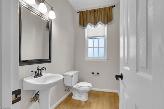 4507 Brandt Ridge Dr, Greensboro, NC 27455 - half bathroom featuring baseboards, wood finished floors, and toilet