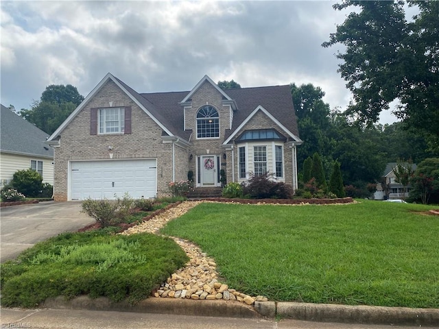 4709 Clifton Park Dr, Jamestown, NC 27282 - traditional home featuring a garage, concrete driveway, brick siding, and a front yard