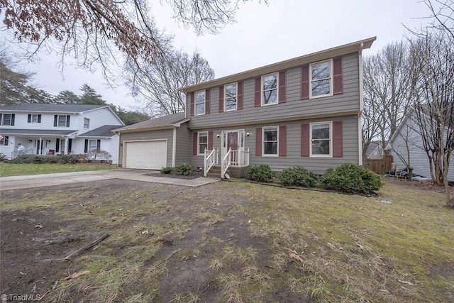 colonial-style house with a front yard and a garage