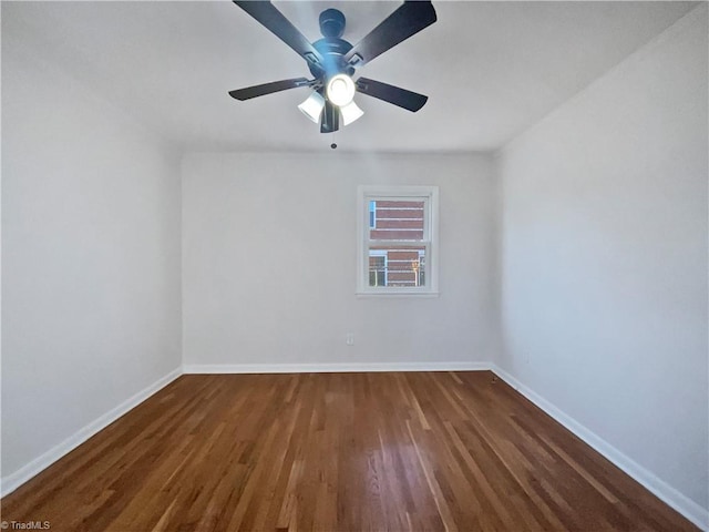 empty room with dark hardwood / wood-style floors and ceiling fan