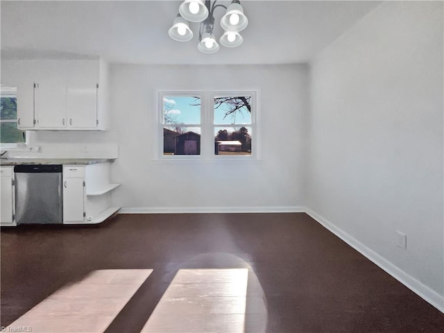 unfurnished dining area with a chandelier