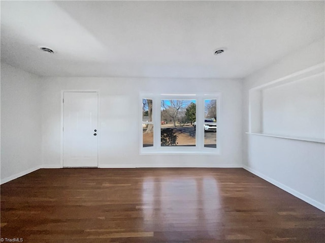 unfurnished room with dark hardwood / wood-style flooring