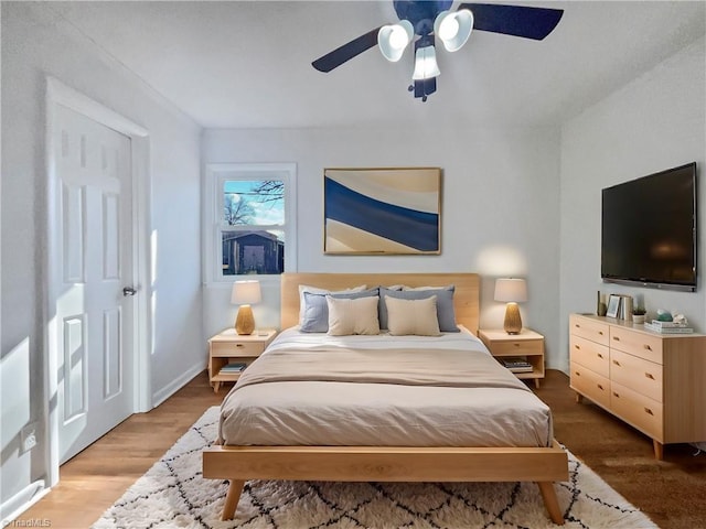 bedroom featuring dark hardwood / wood-style flooring and ceiling fan