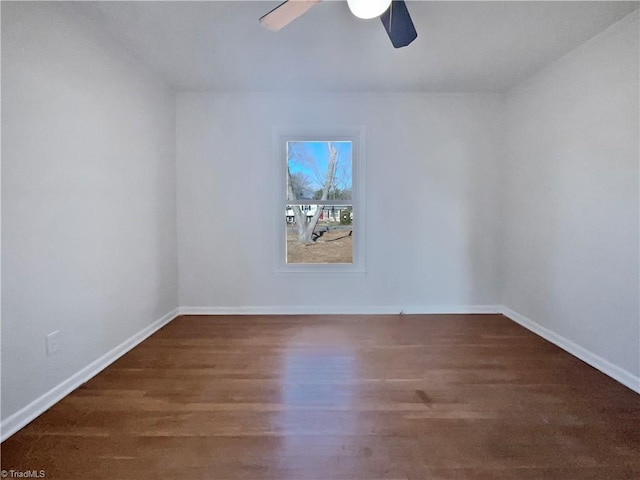 spare room featuring dark wood-type flooring and ceiling fan